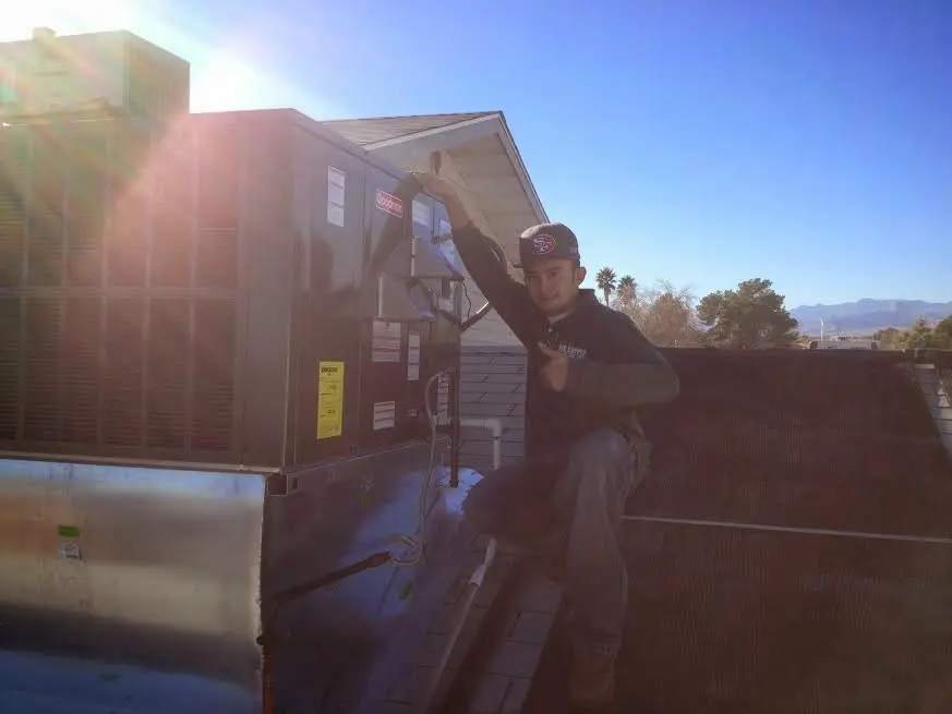 HVAC technician performing HVAC Inspection on a rooftop unit in Dayton